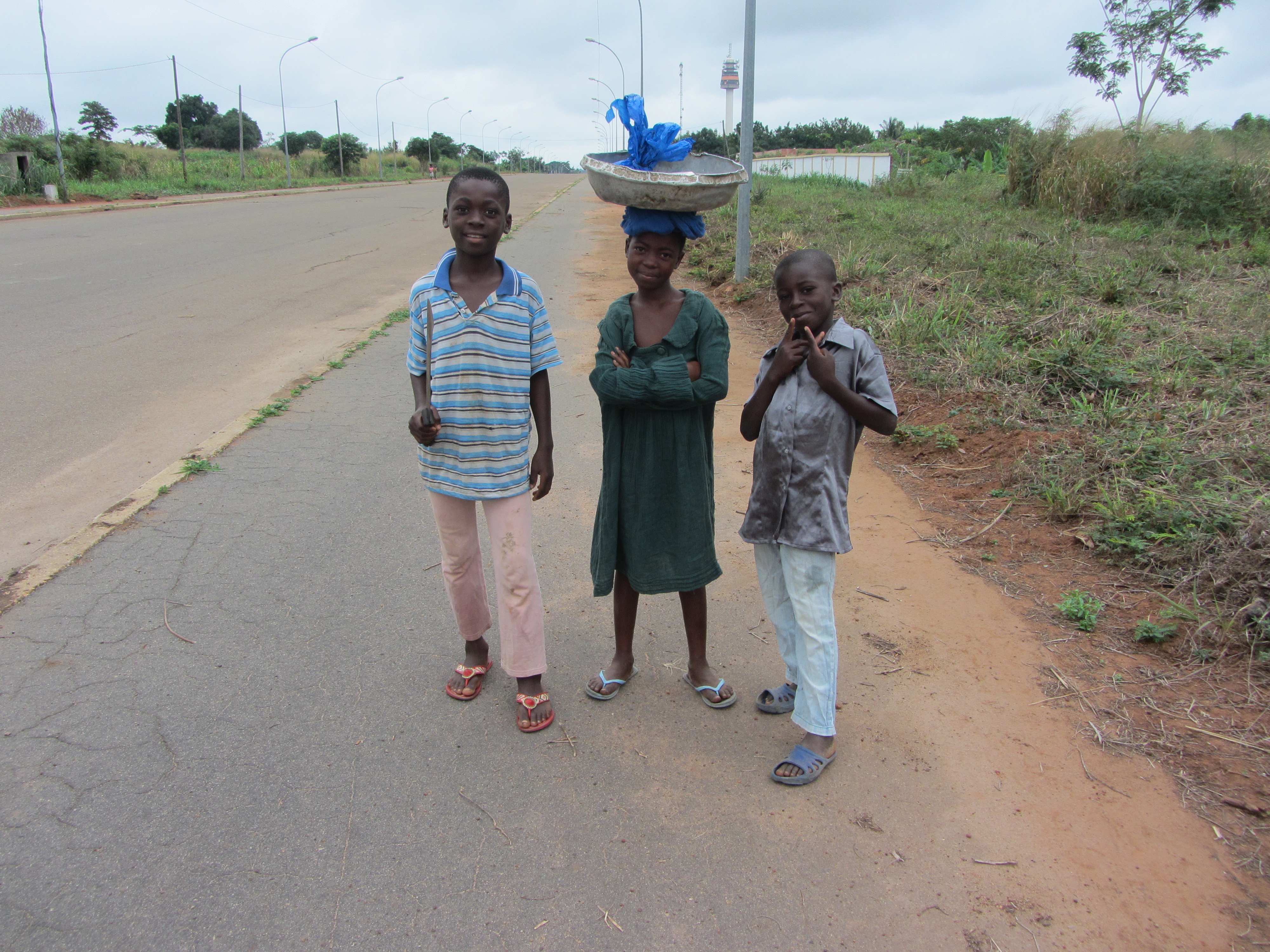 Tres niños en una desertica calle de Yamoussoukro
