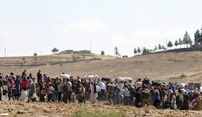 Decenas de miles de kurdos cruzan la frontera turca